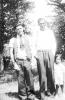 Frank Doucette with unknown and child in front of trees.(Mary Jane Doucette Collection)